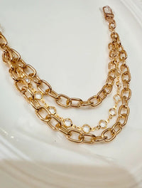 Gold Tone and Rhinestones Handbag Charm Chain layered with gold tone hardware