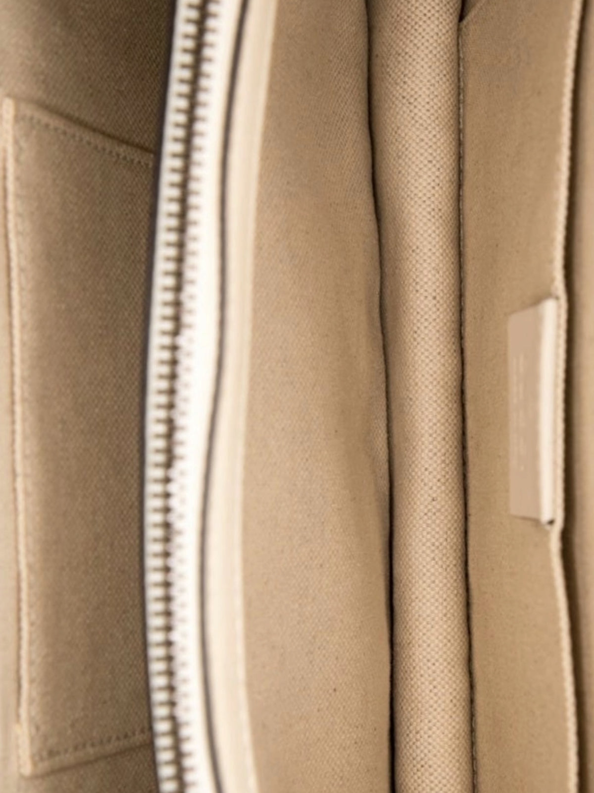 Interior view of YoloLuxe Handbags Gucci bamboo bag featuring beige fabric lining and a secure zippered compartment.