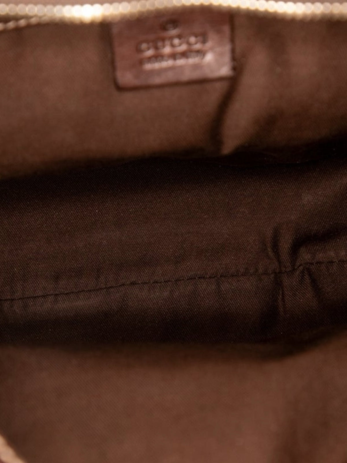 YoloLuxe Handbags Gucci hobo bag interior featuring brown fabric lining and an embossed leather brand logo patch