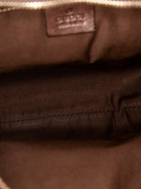 YoloLuxe Handbags Gucci hobo bag interior featuring brown fabric lining and an embossed leather brand logo patch