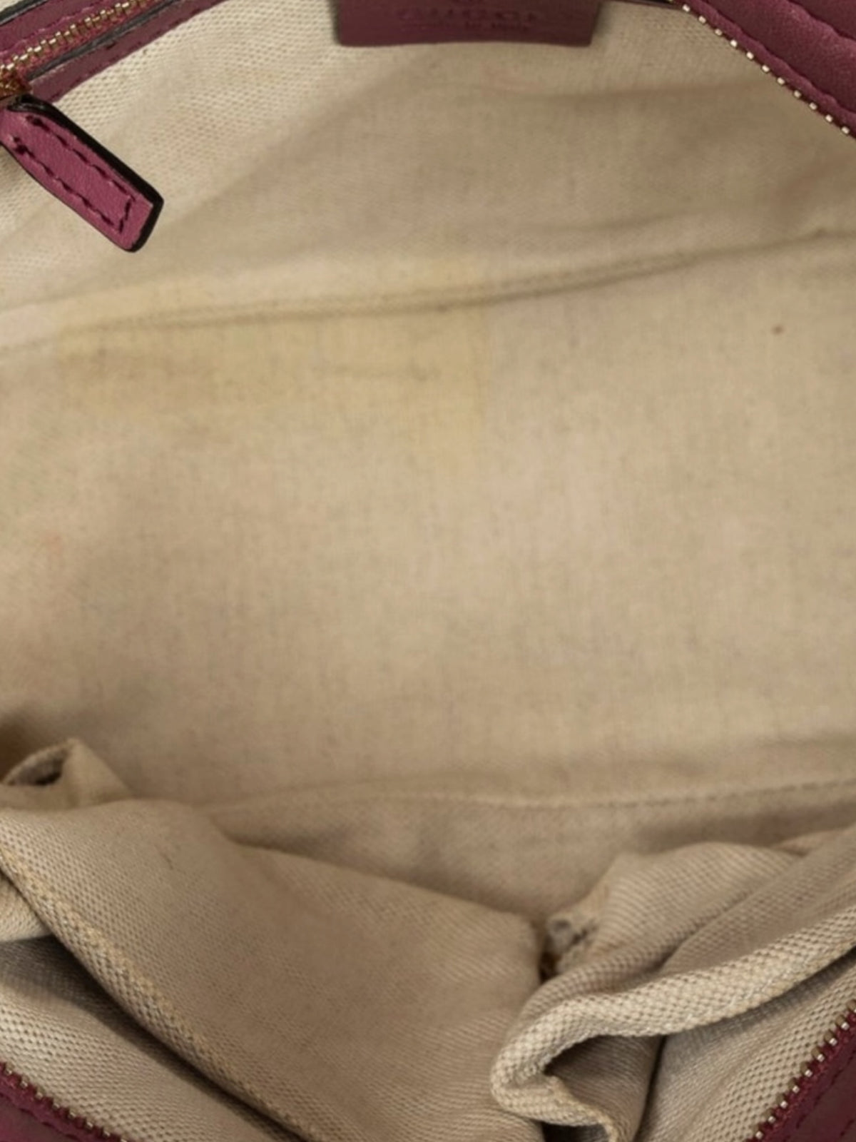 YoloLuxe Handbags Gucci tote interior featuring neutral fabric lining and pink leather trim with zip closure