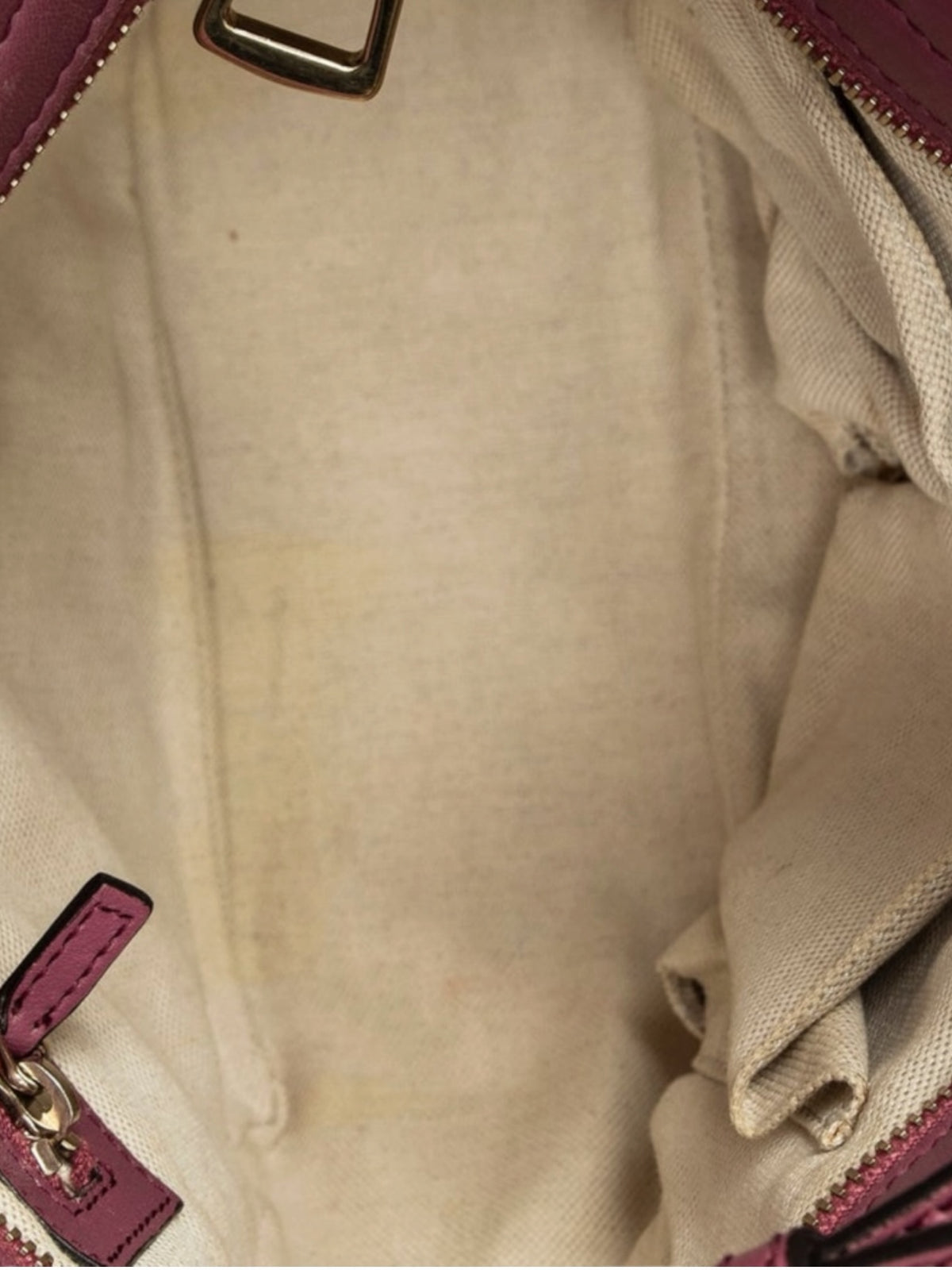 Interior of a YoloLuxe Handbags Gucci tote featuring a neutral fabric lining and pink leather trim details.