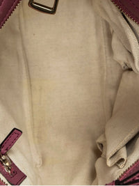 Interior of a YoloLuxe Handbags Gucci tote featuring a neutral fabric lining and pink leather trim details.