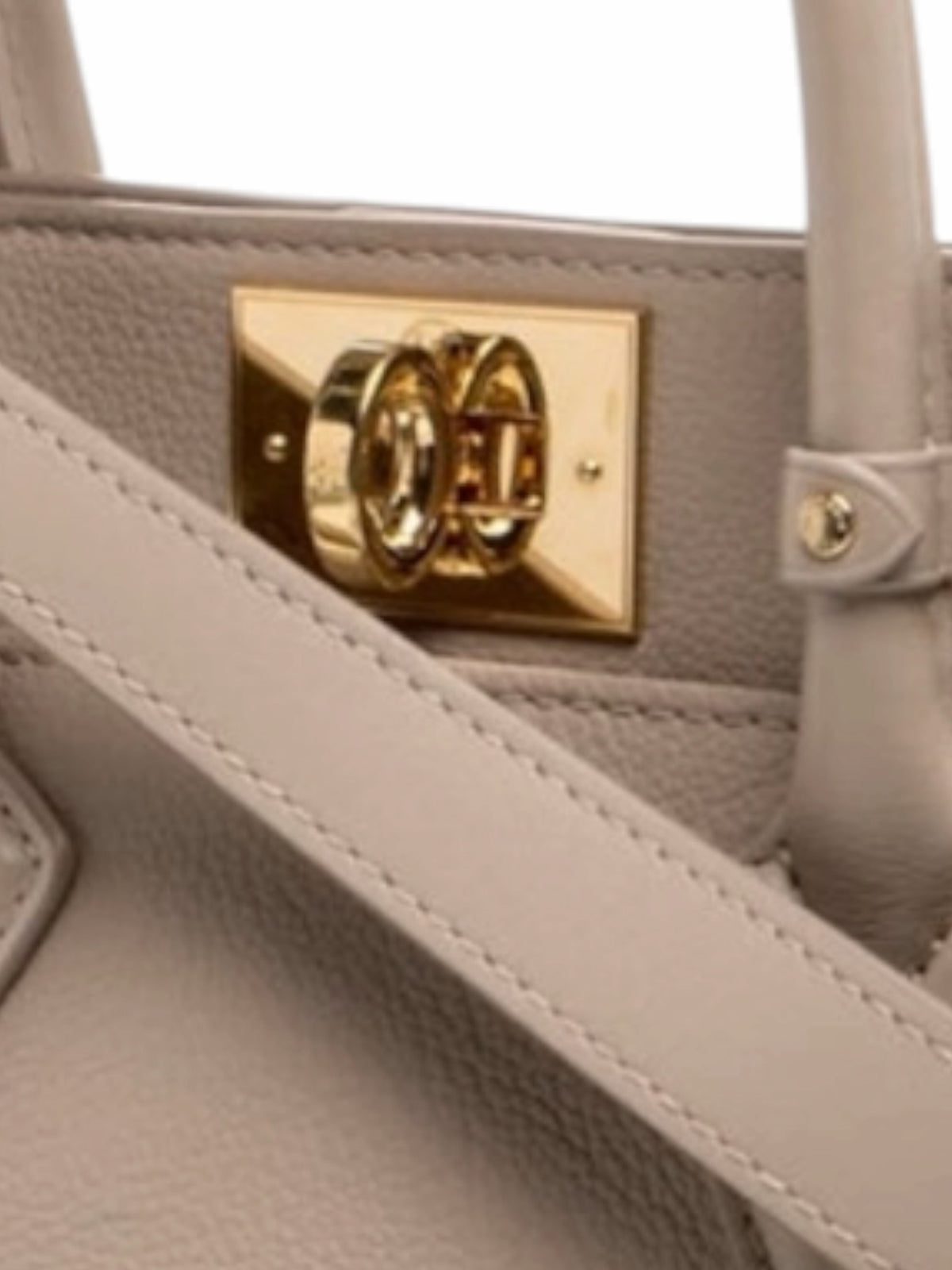 YoloLuxe Handbags taupe leather handbag featuring a polished gold-tone turn-lock closure and top handle detail.