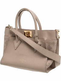 YoloLuxe Handbags taupe leather Louis Vuitton handbag with perforated monogram sides and gold-tone hardware.