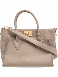 YoloLuxe Handbags taupe leather Louis Vuitton handbag with gold hardware, top handles, and perforated side panels.